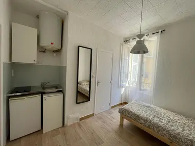 a room with a kitchen and a bed in it at Studio au coeur de Nice in Nice
