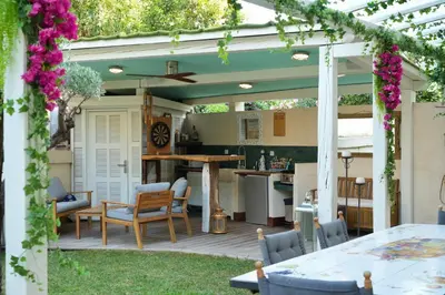 an outdoor patio with a table and chairs at Villa La Mascotte in Beaulieu-sur-Mer