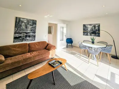 a living room with a couch and a table at Beau 2 pieces avec vue imprenable sur la rade in Villefranche-sur-Mer