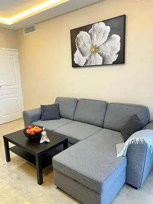 a living room with a couch and a table at Appartement moderne 3 pièces climatisé avec balcon, plage à 2 min in Nice