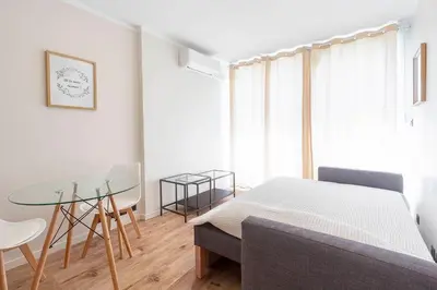 a bedroom with a bed and a table and chairs at Grand studio 4 couchages quartier Musiciens in Nice