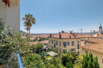 a view of a city with palm trees and buildings at Quiet & Open View - 1 Bdr Large Terrace in Nice