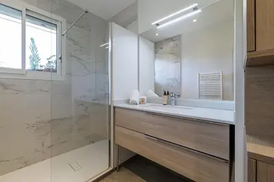 a white bathroom with a sink and a shower at Quiet & Open View - 1 Bdr Large Terrace in Nice