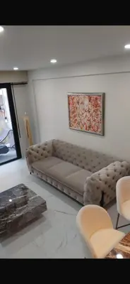 a living room with a couch and a table at Nice in Nice