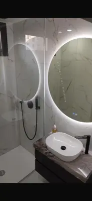 a bathroom with a sink and a shower with a mirror at Nice in Nice