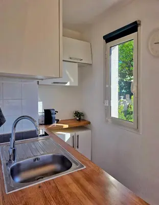 a kitchen with a sink and a window at Studio près mer et aéroport - Studio near sea and airport in Nice