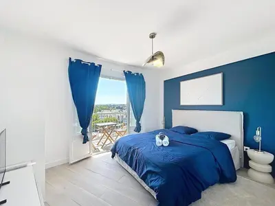 a blue bedroom with a bed and a balcony at Beautiful 4 rooms sea airport in Nice