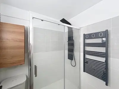 a shower with a glass door in a bathroom at Beautiful 4 rooms sea airport in Nice