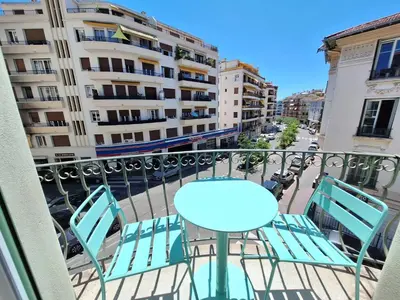 a balcony with a blue table and chairs at Iconic and bright style in Nice in Nice