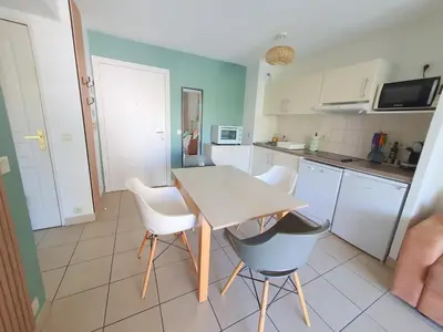 a living room with a couch and a large window at 2P pour 4 personnes grande terrasse avec lit parapluie piscine sur le toit et parking en sous-sol in Cagnes-sur-Mer