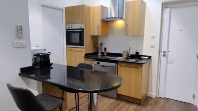 a kitchen with a black counter top in a room at 17 Cassini in Nice