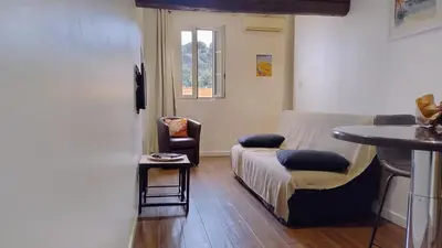a room with a bed and a table and a chair at 17 Cassini in Nice