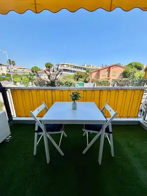 a white table and chairs on a balcony at Studio rénové à deux pas de la mer et commerces in Cagnes-sur-Mer