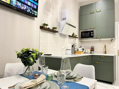 a kitchen with a table and chairs and a kitchen with a counter at Pearl of Nice in Nice