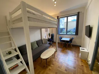 a living room with a bunk bed and a desk at Easy and accessible beach flat near the university in Nice