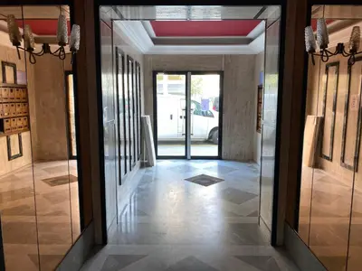 a hallway with glass doors in a building at Easy and accessible beach flat near the university in Nice