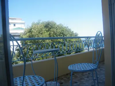 two blue chairs sitting on a balcony at Apartment Villa HenriIV in Nice