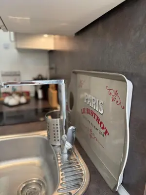a kitchen sink with a kitchenaid strainer next to a kitchen sink at Charmant studio en centre de Nice in Nice