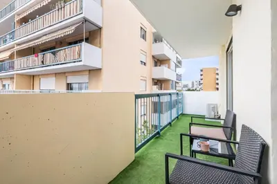 a balcony with chairs and a table on a building at Azur Stay 3 Start Beach 8 min Tram Airport 5m in Nice