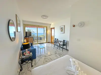 a kitchen with a counter with a sink and a window at Riviera Escape Promenade Nice in Nice