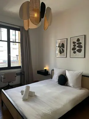 a bedroom with a large white bed with two pillows at Chic et confort- Nice- 3 à 5 personnes in Nice