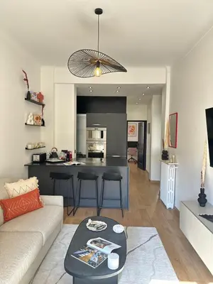 a living room and kitchen with a couch and a table at Chic et confort- Nice- 3 à 5 personnes in Nice