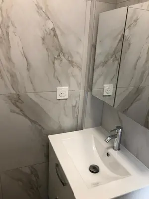 a white bathroom with a sink and a mirror at Le St Lambert, Grand Studio Libération in Nice