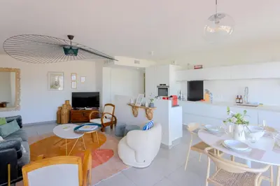 a kitchen and living room with a table and chairs at Green Hill Appartement à Nice Terrasse 130m2, Vue panoramique, Piscine, Parking Privé, Climatisation, WiFi in Nice