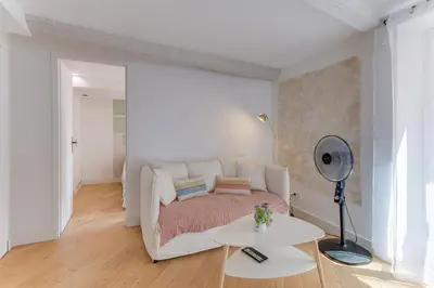 a living room with a couch and a table at AUTHENTIC VILLEFRANCHE AP4472 By Riviera Holiday Homes in Villefranche-sur-Mer