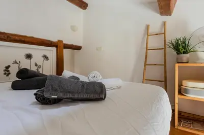 a bedroom with a bed with towels on it at Antibes Centre 2 pièces cosy proche remparts in Nice