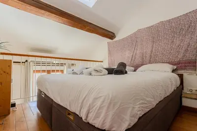 a bedroom with a large bed with white sheets at Antibes Centre 2 pièces cosy proche remparts in Nice