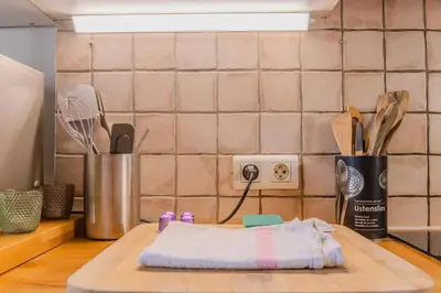 a cutting board with a towel on top of a kitchen counter at Antibes Centre 2 pièces cosy proche remparts in Nice