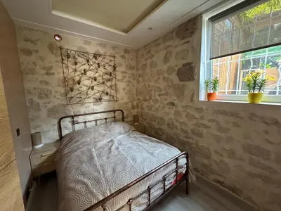 a small bedroom with a bed and a window at Terrasse de Cimiez in Nice