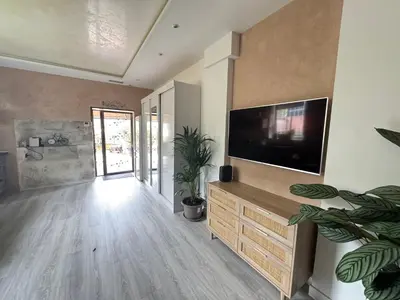 a living room with a flat screen tv on a wall at Terrasse de Cimiez in Nice