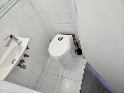 a bathroom with a toilet and a sink at Logement vue mer - Nice ouest in Nice