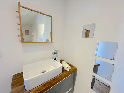 a bathroom with a white sink and a mirror at ⁂ Cocon ensoleillé proche de la plage in Nice