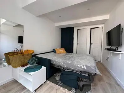a small bedroom with a bed and a tv at Appartement rénové Vieux Nice in Nice