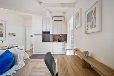 a living room with a couch and a kitchen at Charme et confort - Nice Centre Libération in Nice