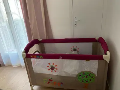 a baby crib in a corner of a room at Plage et Salsa, Nice Promenade des anglais in Nice