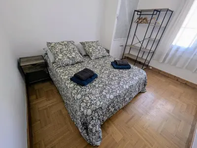 a bedroom with a bed with two pillows on it at Bel appartement proche centre 15 minutes in Nice