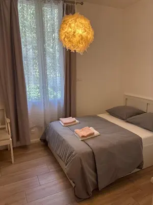 a bedroom with two beds and a chandelier at Renovated F3 Parking Clim Nice Mont Boron in Nice
