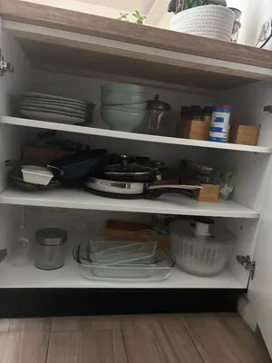 a kitchen shelf filled with dishes and plates at Renovated F3 Parking Clim Nice Mont Boron in Nice