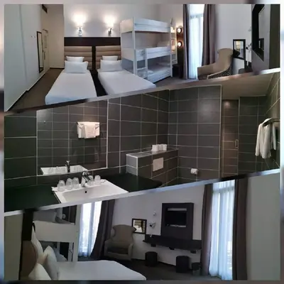 a large bathroom with a bed and a sink at Hôtel & Appartements Monsigny in Nice