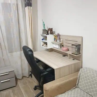 a desk in a room with a chair and a computer at CHAMBRE CHEZ L HABITANT AVEC SDB ET WC sans cuisine in Nice