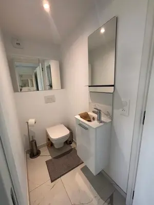 a bathroom with a toilet and a sink and a mirror at SEASIDE VIEW Saint Laurent in Saint-Laurent-du-Var
