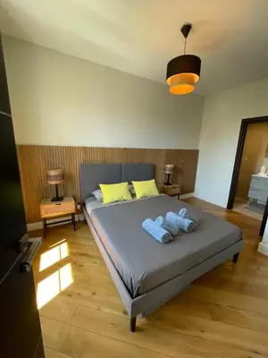 a living room with a flat screen tv on a brick wall at Villa Katerina - Luxury Apartment in Nice