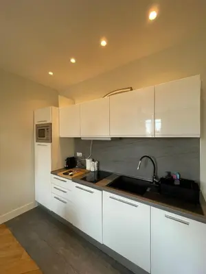 a kitchen with white cabinets and a sink at Villa Katerina - Luxury Apartment in Nice