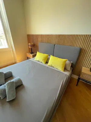 a large bed with two yellow pillows in a bedroom at Villa Katerina - Luxury Apartment in Nice