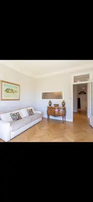 a living room with a bed and a table at Le Grand Bourgeois à Nice in Nice