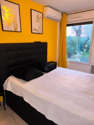 a bedroom with a large bed and a window at 1 Chambre pour 2 personnes in Nice